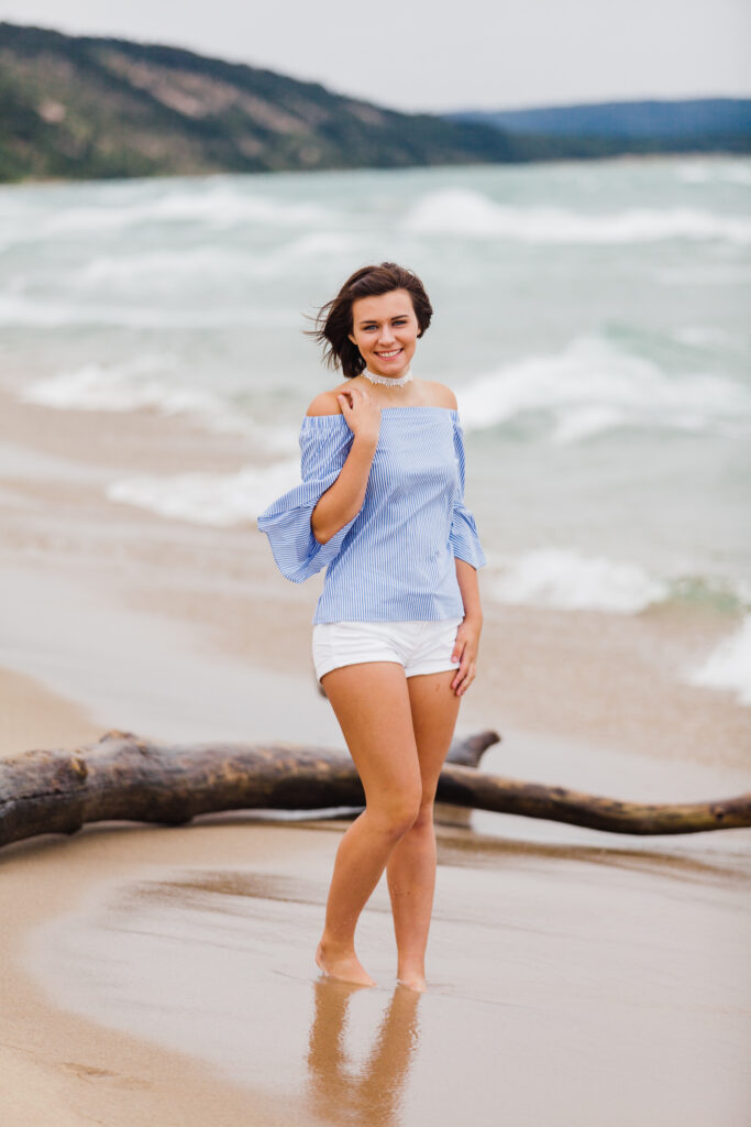senior girl standing on the beach